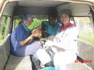 Krista Simonson, Joan Muraya and Emily Egan with their gifted chicken in the back of the taxi